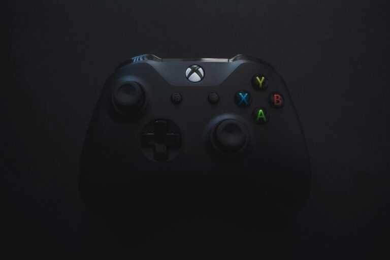 Xbox controller illuminated against a dark background, perfect for gaming themes.